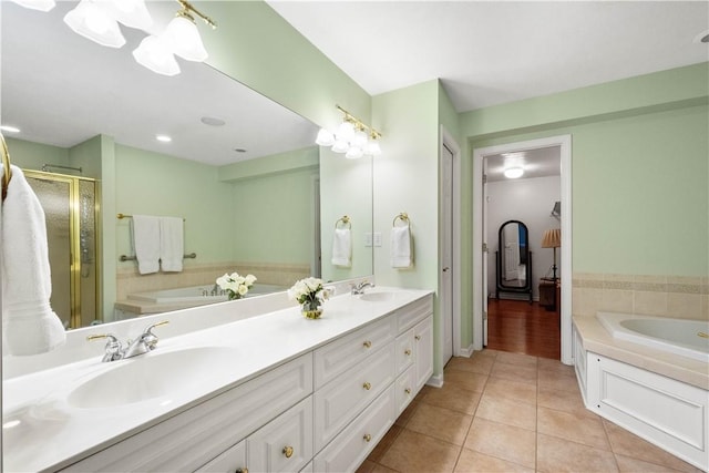 bathroom featuring tile patterned flooring, vanity, and shower with separate bathtub