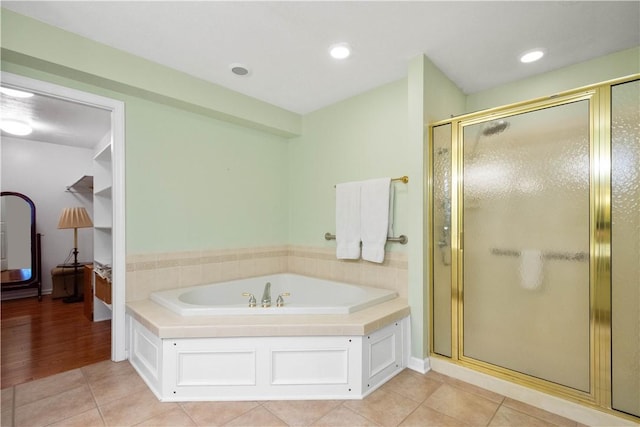 bathroom featuring tile patterned floors and shower with separate bathtub