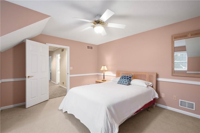 carpeted bedroom with vaulted ceiling and ceiling fan