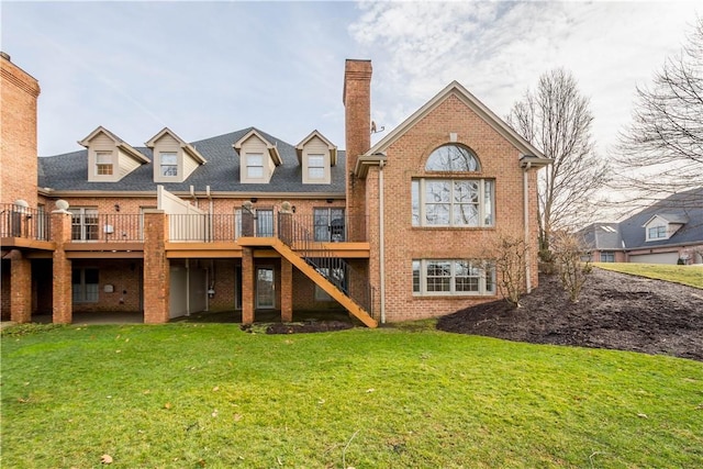 back of house featuring a lawn and a deck