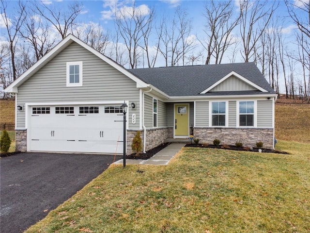 view of front of property featuring a garage and a front yard