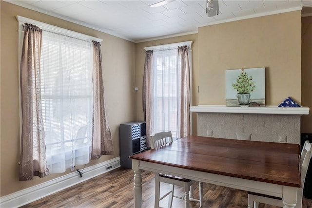 dining area featuring hardwood / wood-style floors and ornamental molding