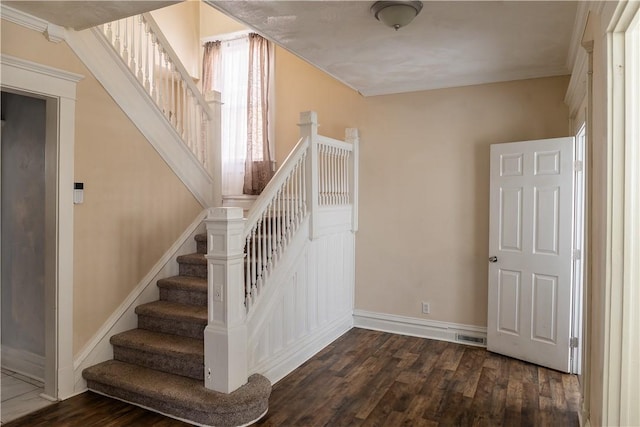 stairway with hardwood / wood-style flooring