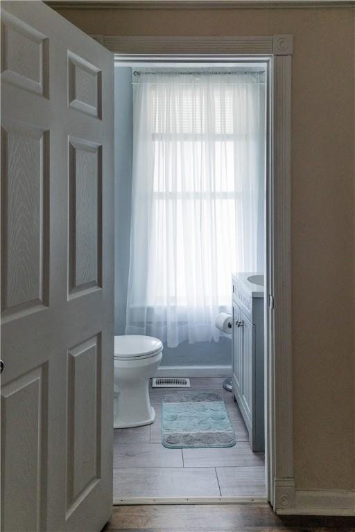 bathroom featuring vanity, toilet, and hardwood / wood-style floors