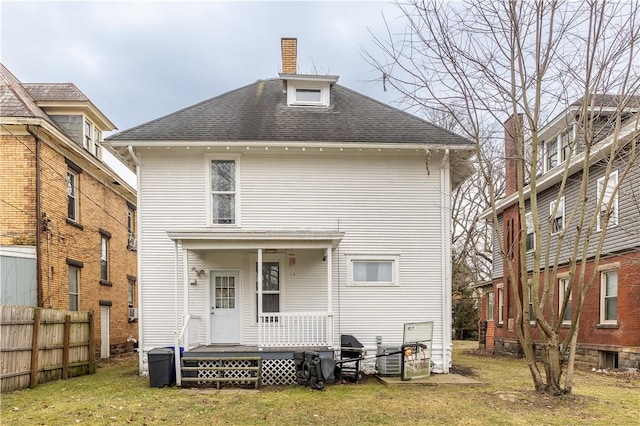 back of property featuring a yard