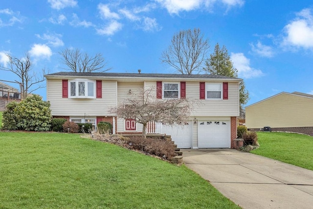 raised ranch with a garage and a front yard