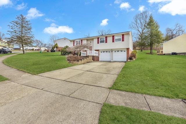 split foyer home featuring a garage and a front lawn