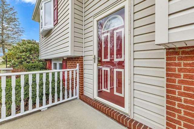 view of exterior entry with covered porch