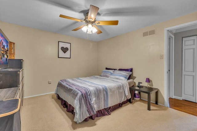 bedroom with ceiling fan and light colored carpet