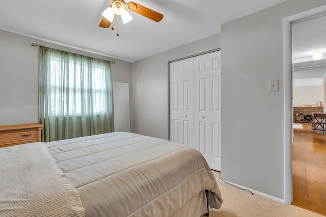 bedroom featuring light carpet, a closet, and ceiling fan