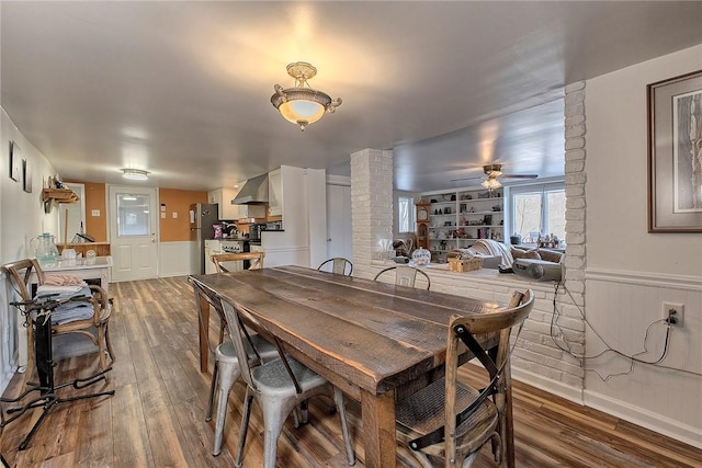 dining space with hardwood / wood-style floors and ceiling fan