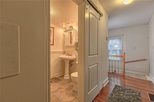 bathroom featuring toilet and hardwood / wood-style floors