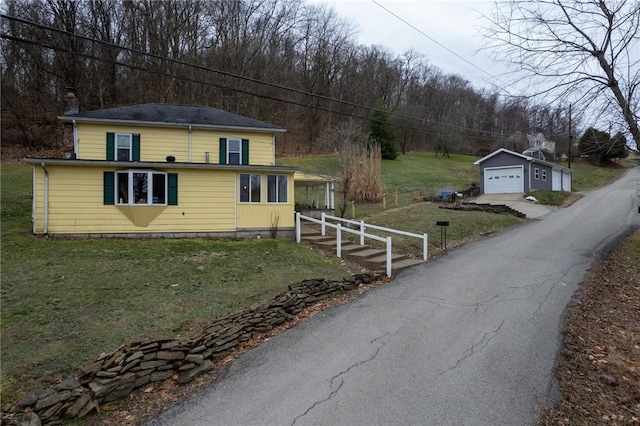 exterior space featuring a garage, an outdoor structure, and a yard