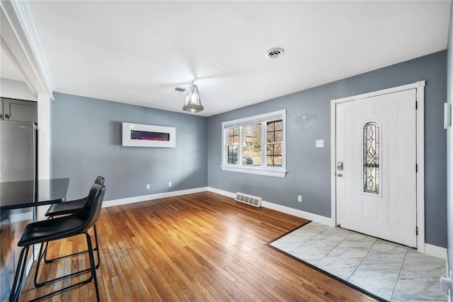 foyer entrance with light wood-type flooring