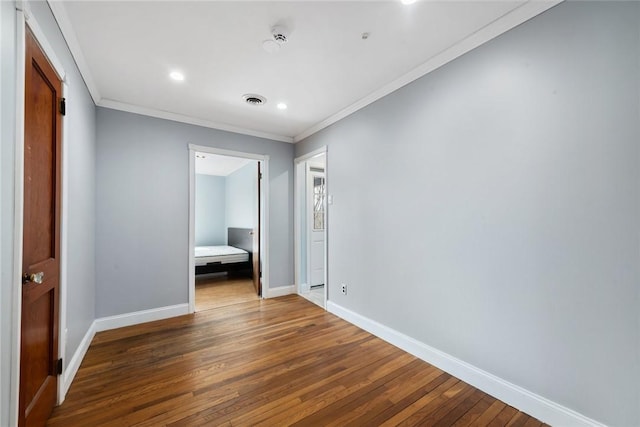 interior space with crown molding and hardwood / wood-style flooring