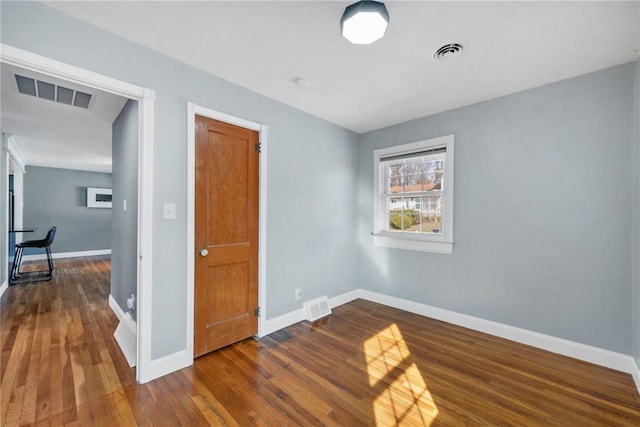 empty room with hardwood / wood-style flooring