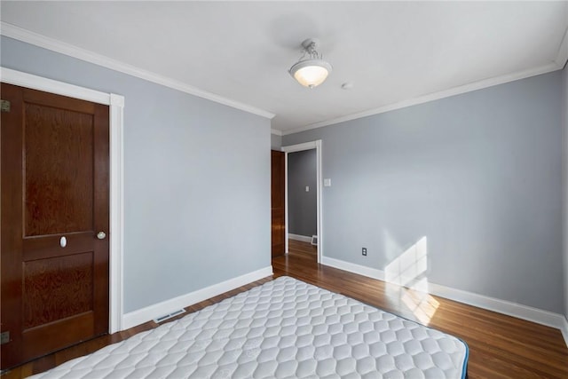 unfurnished bedroom with hardwood / wood-style flooring and ornamental molding