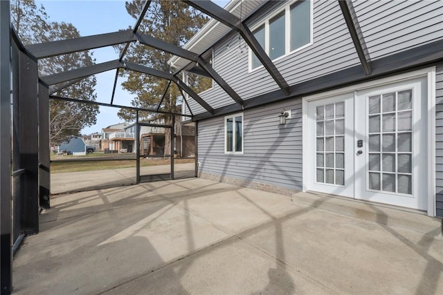 view of patio / terrace featuring french doors and glass enclosure