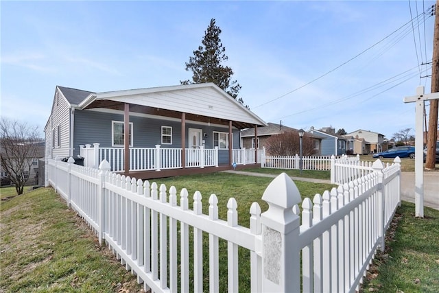 view of front facade with a front lawn and covered porch