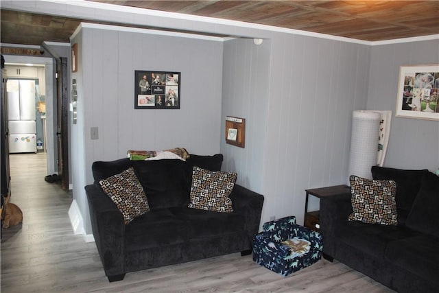 living room with crown molding, hardwood / wood-style floors, and wooden ceiling