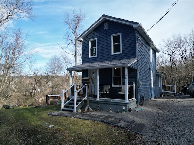 view of front of home with a porch and a front lawn