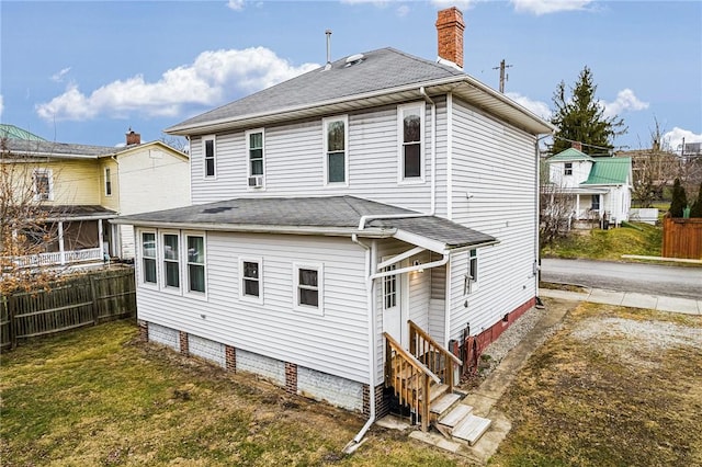 back of house featuring a lawn