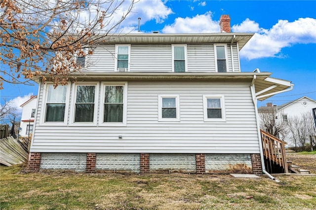 view of side of home featuring a lawn