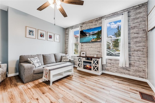 living room featuring ceiling fan and light hardwood / wood-style floors