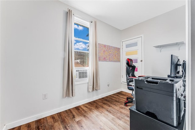 workout room with hardwood / wood-style flooring and cooling unit