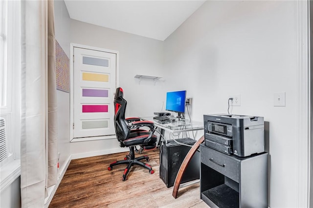 office with lofted ceiling and hardwood / wood-style floors