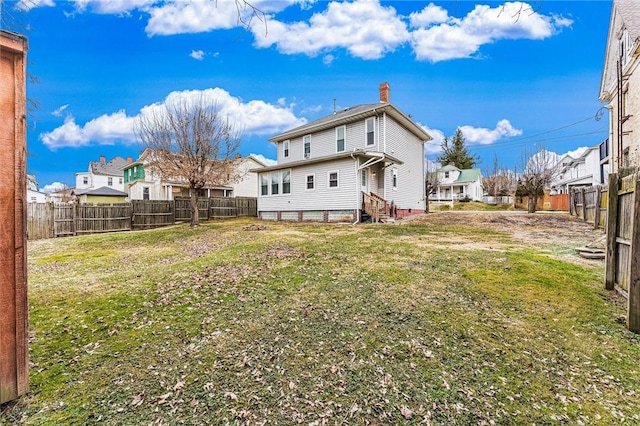 rear view of house with a lawn