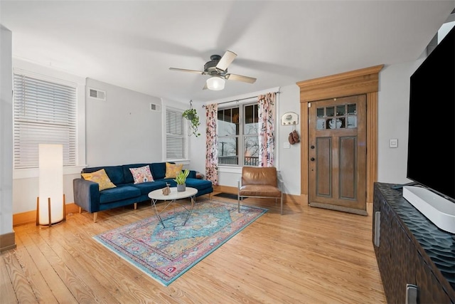 living room with ceiling fan and light wood-type flooring