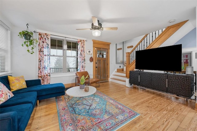 living room with ceiling fan and light wood-type flooring