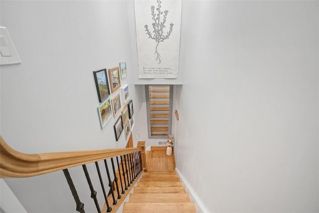 stairs with hardwood / wood-style flooring