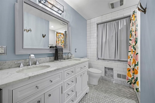 bathroom featuring vanity, tile walls, tile patterned floors, and toilet