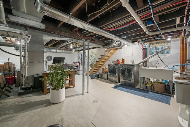 basement with washer and clothes dryer and sink