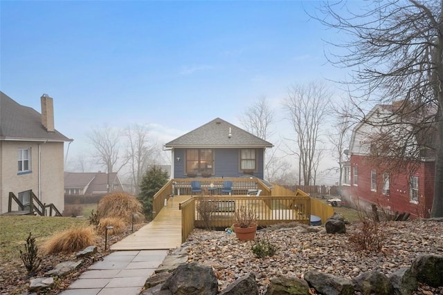 back of property with a wooden deck