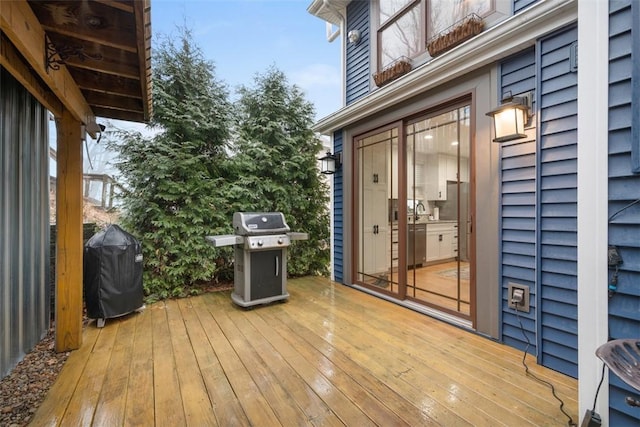 wooden terrace with area for grilling and sink