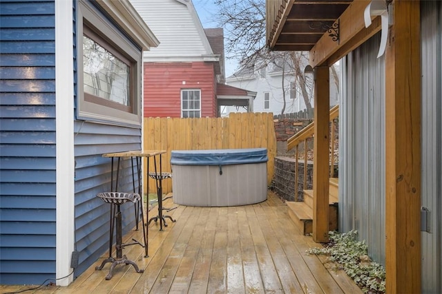 wooden deck featuring a hot tub