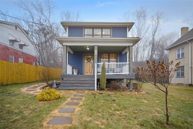 view of front of house featuring covered porch and a front yard