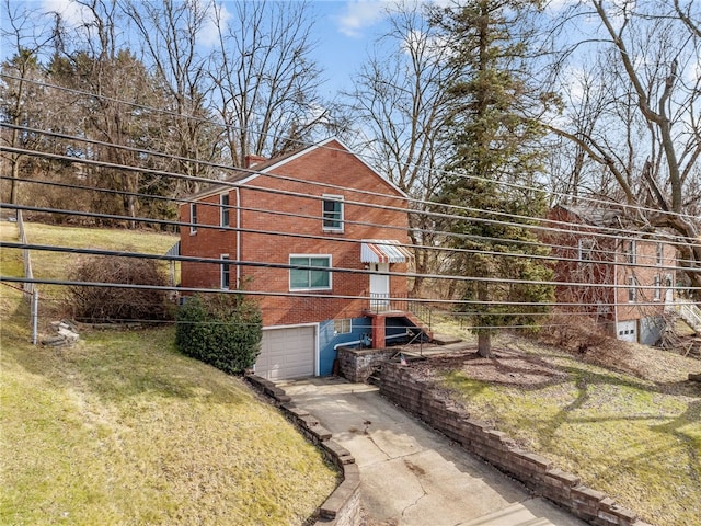 view of side of home featuring a garage and a yard