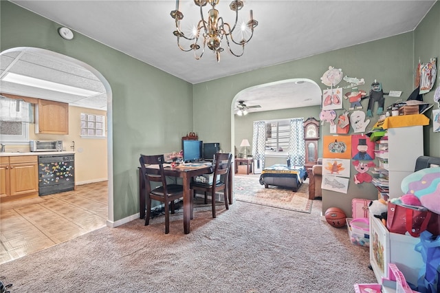 interior space with light carpet, ceiling fan with notable chandelier, beverage cooler, and a healthy amount of sunlight