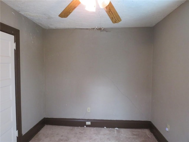 empty room with baseboards and a ceiling fan