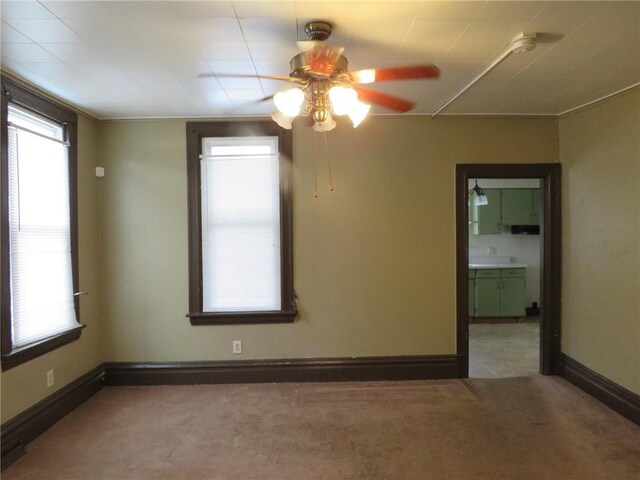 carpeted spare room with ceiling fan