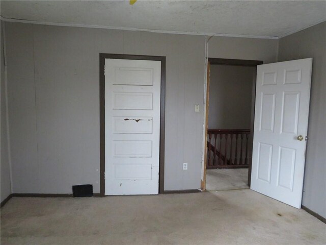 unfurnished bedroom featuring crown molding