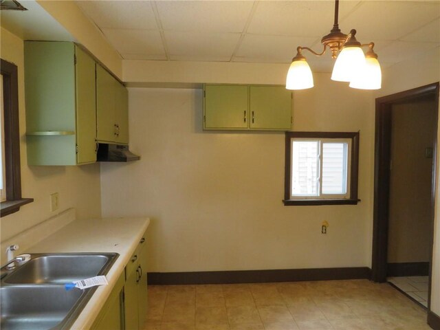 kitchen with pendant lighting, sink, and green cabinets