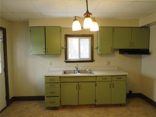 kitchen featuring sink, a paneled ceiling, and green cabinets