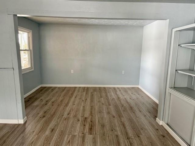 spare room featuring dark wood-type flooring