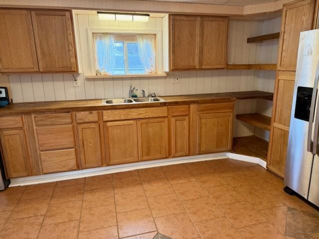 kitchen with sink, stainless steel fridge, and range