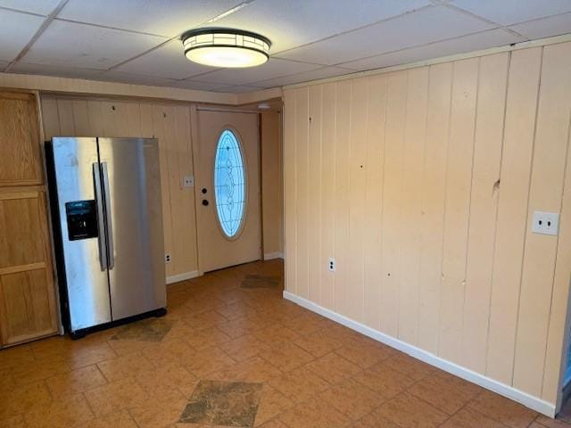 entrance foyer with a paneled ceiling and wooden walls